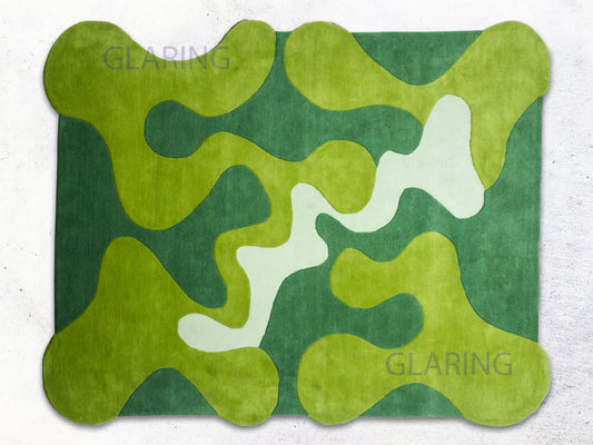 A rectangular rug with a green and white abstract design. The rug features a dark green background with lighter green and white organic shapes.