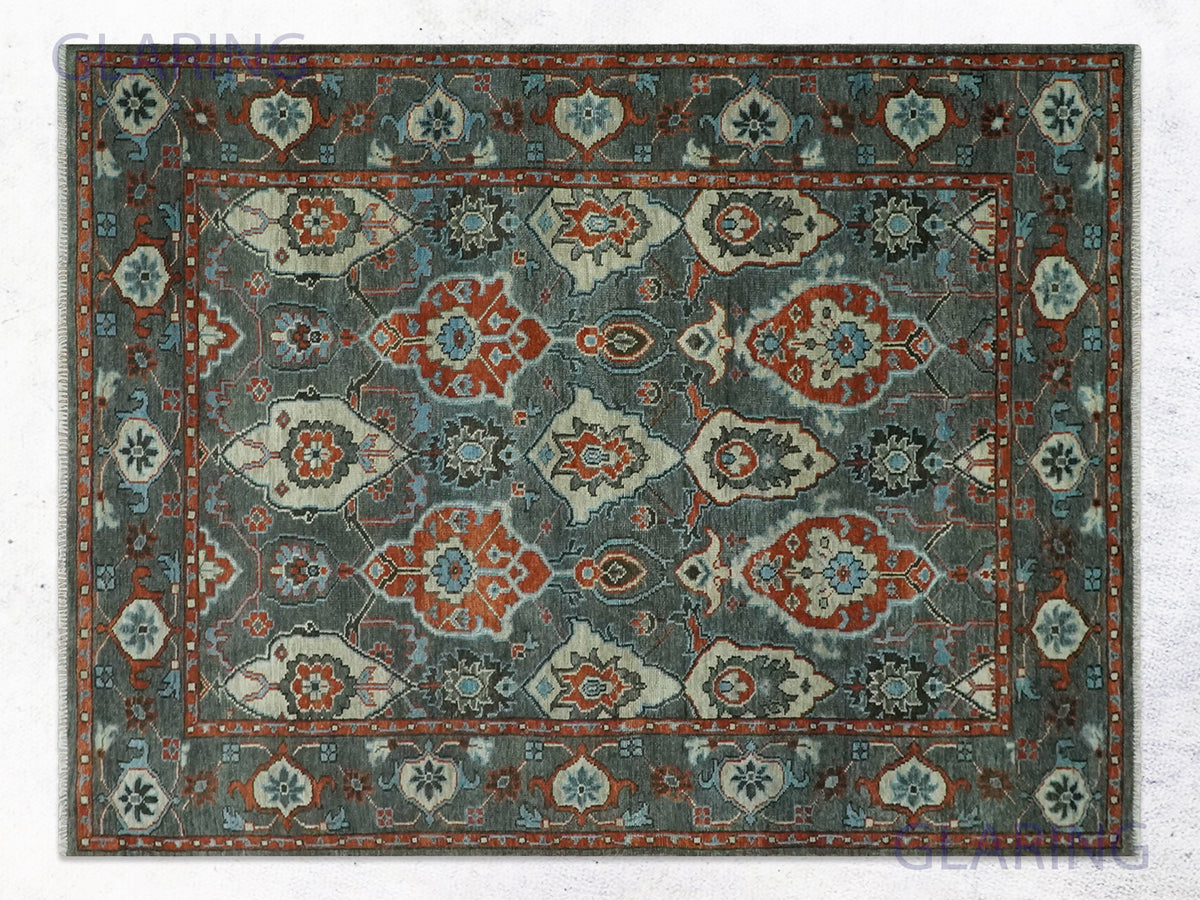 Charcoal mahal floral rug with rust palmettes, teal rosettes, and a wide rust-red border.