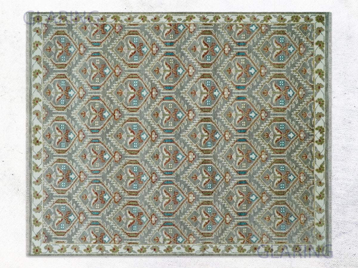 Silver geometric tribal rug with a grey diamond lattice and ivory scrolling vine border.