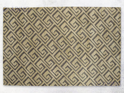 A rectangular rug with a geometric design featuring diamonds in beige and brown colors.