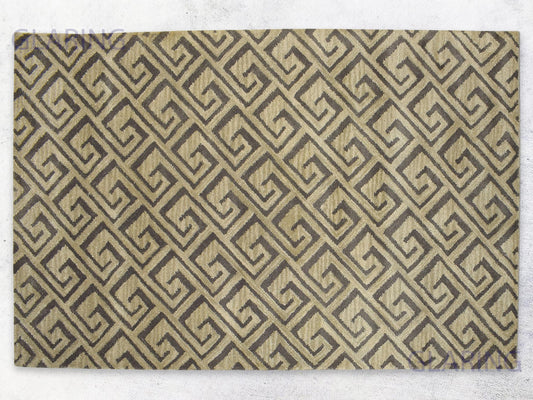 A rectangular rug with a geometric design featuring diamonds in beige and brown colors.