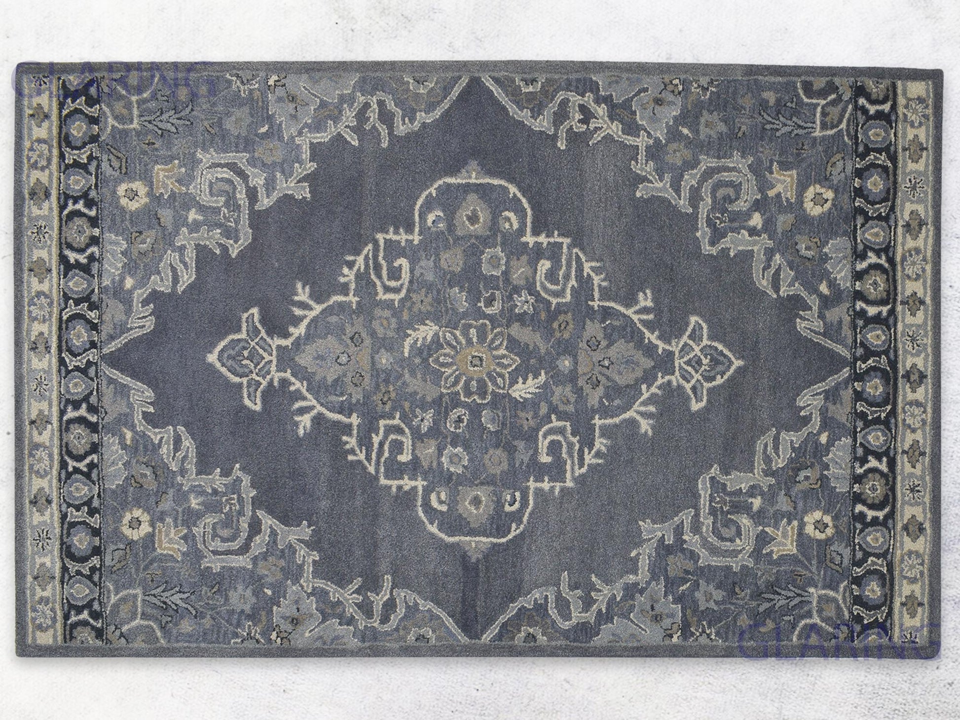 A handcrafted Heriz-Indian area rug with a geometric pattern in gray, ivory, and beige, featuring a medium-cut pile.