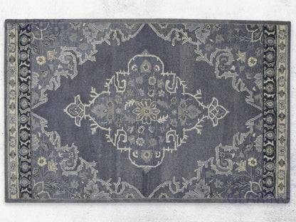 A handcrafted Heriz-Indian area rug with a geometric pattern in gray, ivory, and beige, featuring a medium-cut pile.