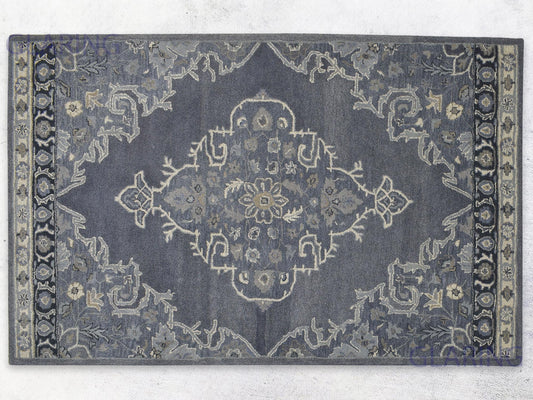 A handcrafted Heriz-Indian area rug with a geometric pattern in gray, ivory, and beige, featuring a medium-cut pile.
