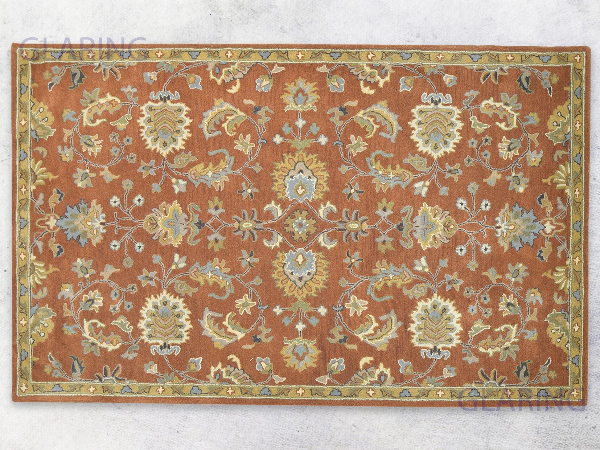 A handcrafted Oushak area rug with a geometric pattern in rust, ivory, and blue colors, featuring a medium-cut pile.