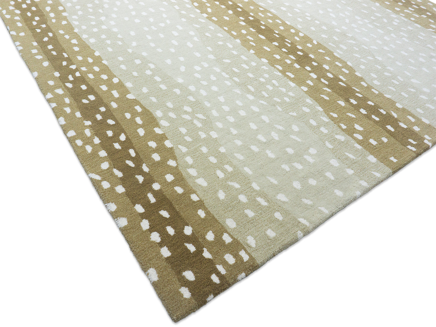 Close-up of a patterned rug with beige and white colors on a plain background