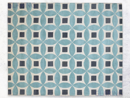 A handmade Moroccan rug with a geometric design featuring blue, grey, and ivory colors.