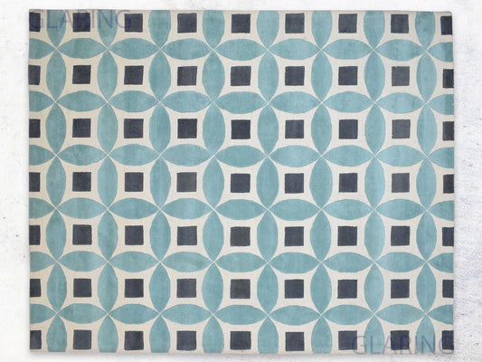 A handmade Moroccan rug with a geometric design featuring blue, grey, and ivory colors.